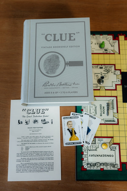 Clue board game with vintage bookshelf edition packaging on a wooden surface