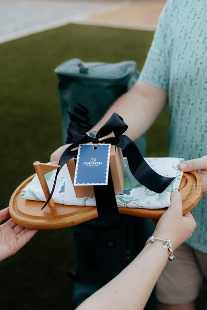 Person gifting someone a curated magic Golf gift