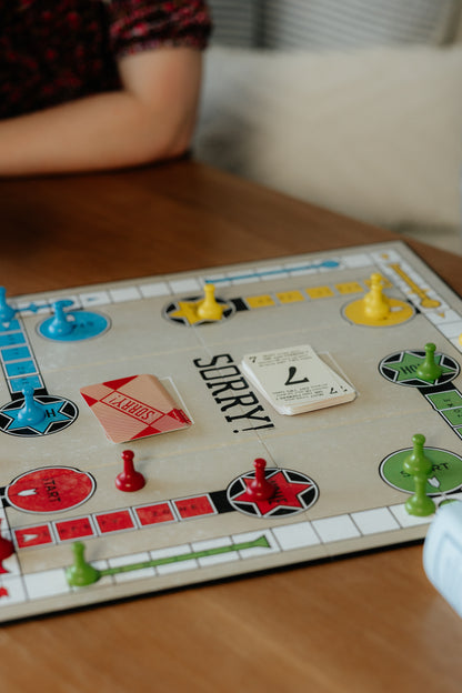 Sorry! Board game with colorful pieces on a wooden table