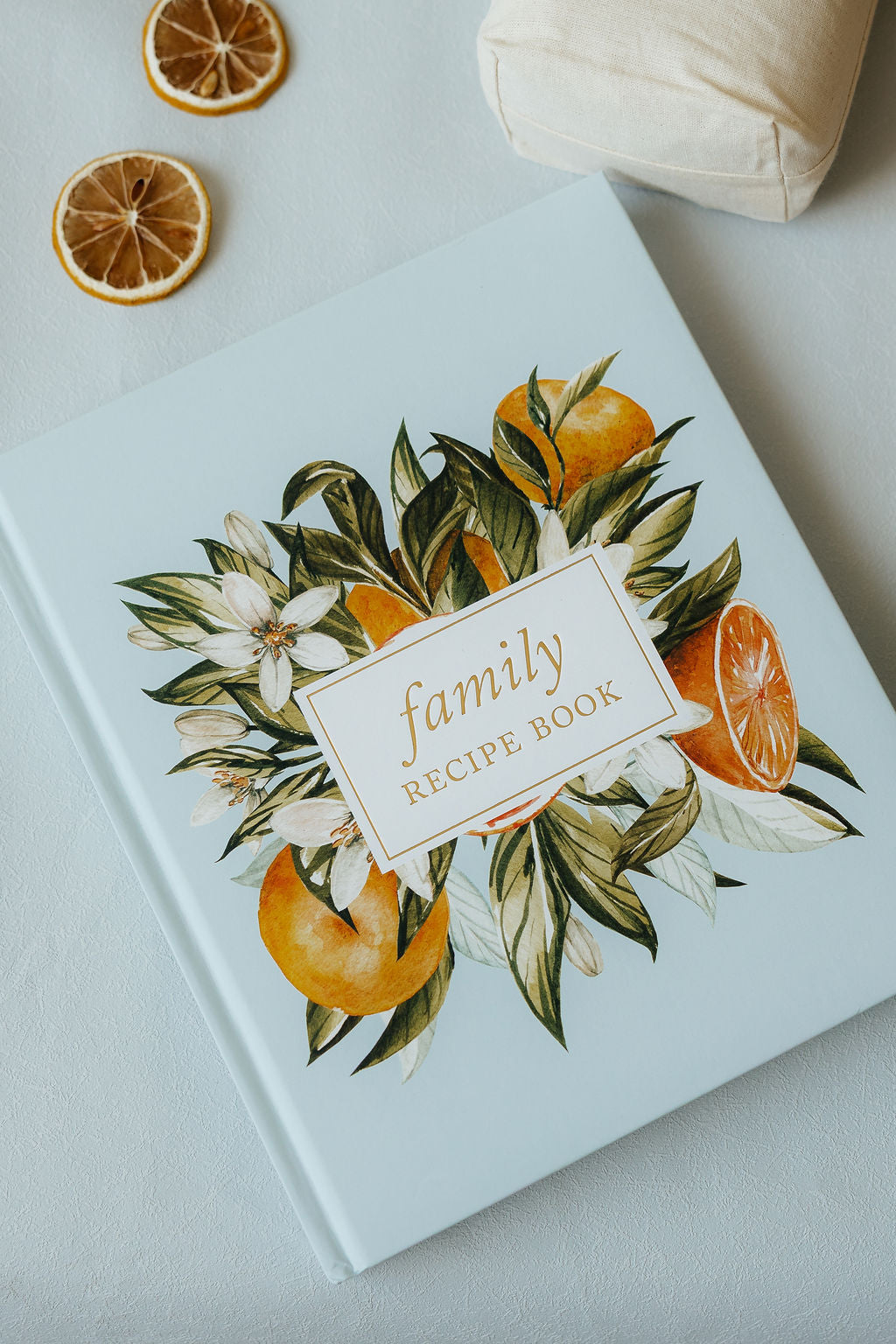 Family recipe book with orange and floral design on a light surface