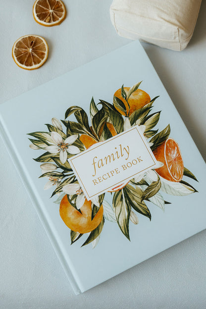 Family recipe book with orange and floral design on a light surface